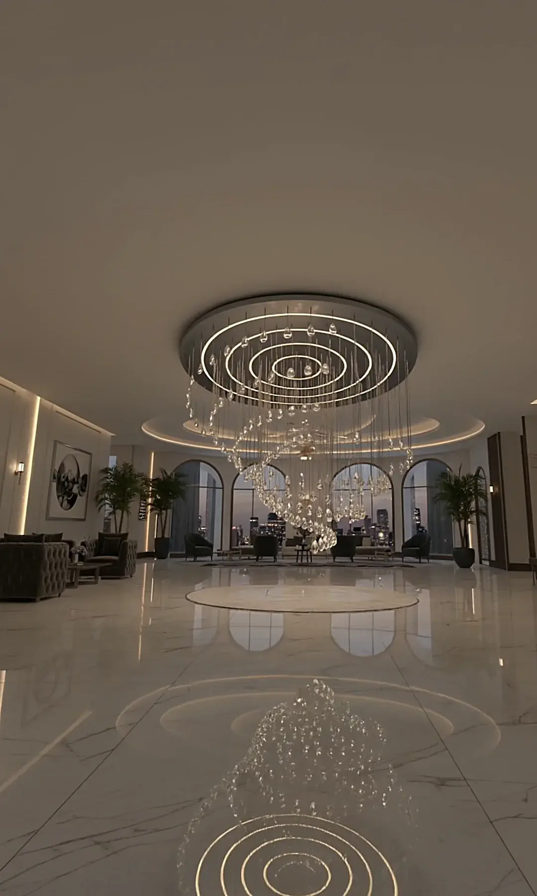 A kinetic chandelier of concentric rings and a crystal spiral in a hotel lobby